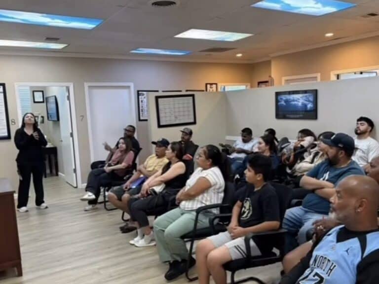 A woman speaks to a room of seated patients during a class at Premier Chiropractic in Stockton